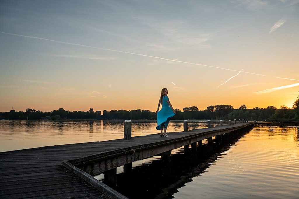 Sunset over the water on a wooden pier in Rotterdam